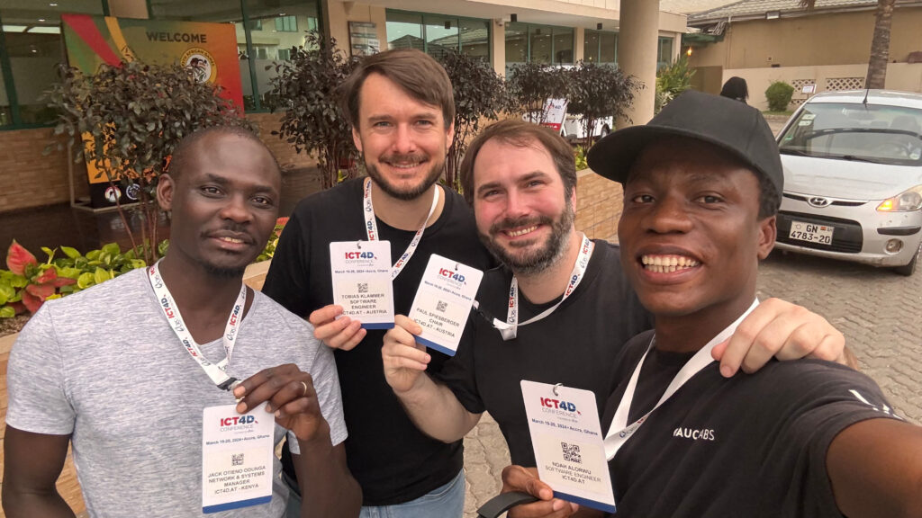 ICT4D.at members show off their conference badges, from left to right: Jack, Tobias, Paul and Noah
